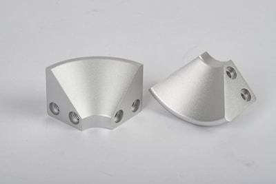 a pair of metal parts on a white background