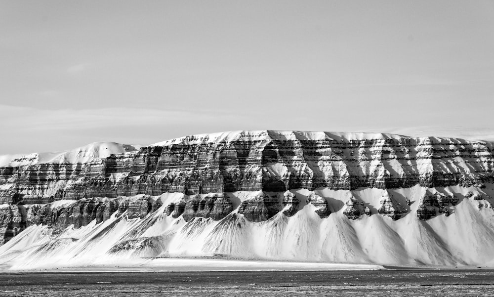 a black and white photo of a snowy mountain