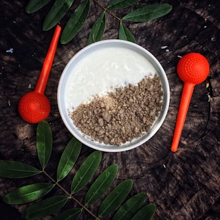 a bowl of oatmeal with a spoon next to it