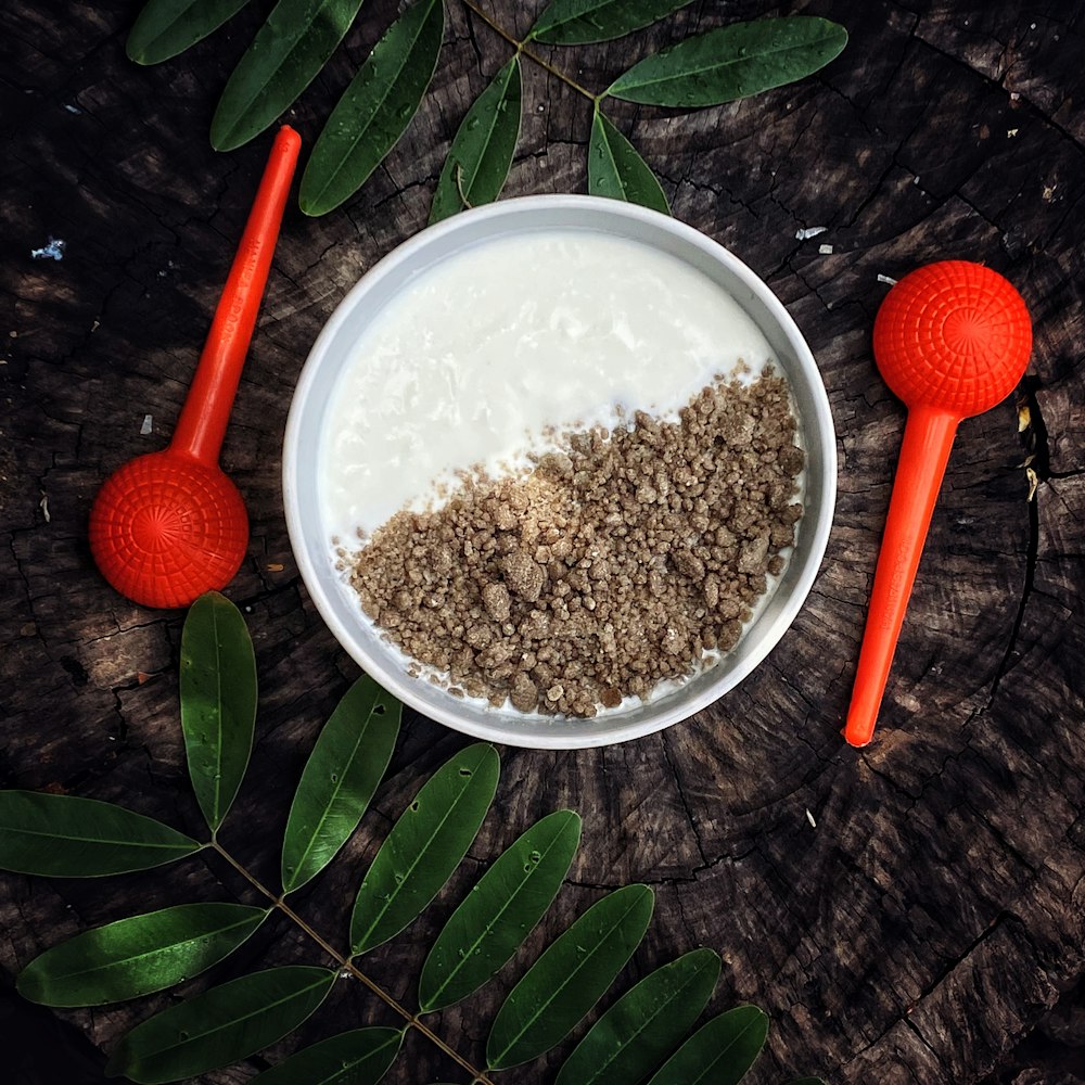 a bowl of oatmeal with a spoon next to it