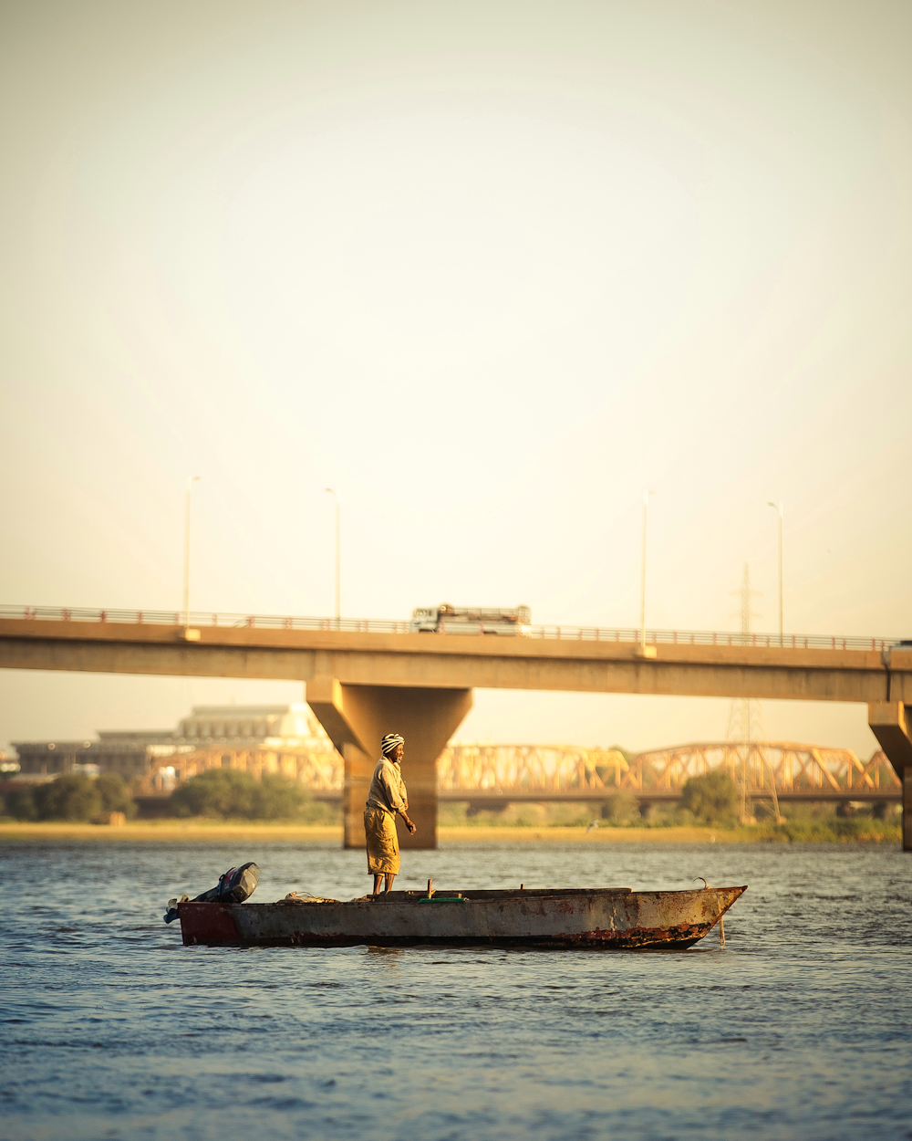 a man standing on a small boat in the water