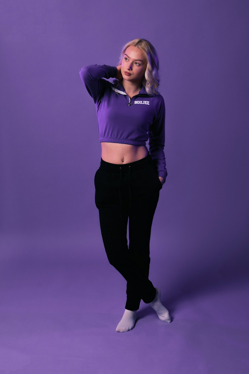 a woman in a purple shirt and black pants