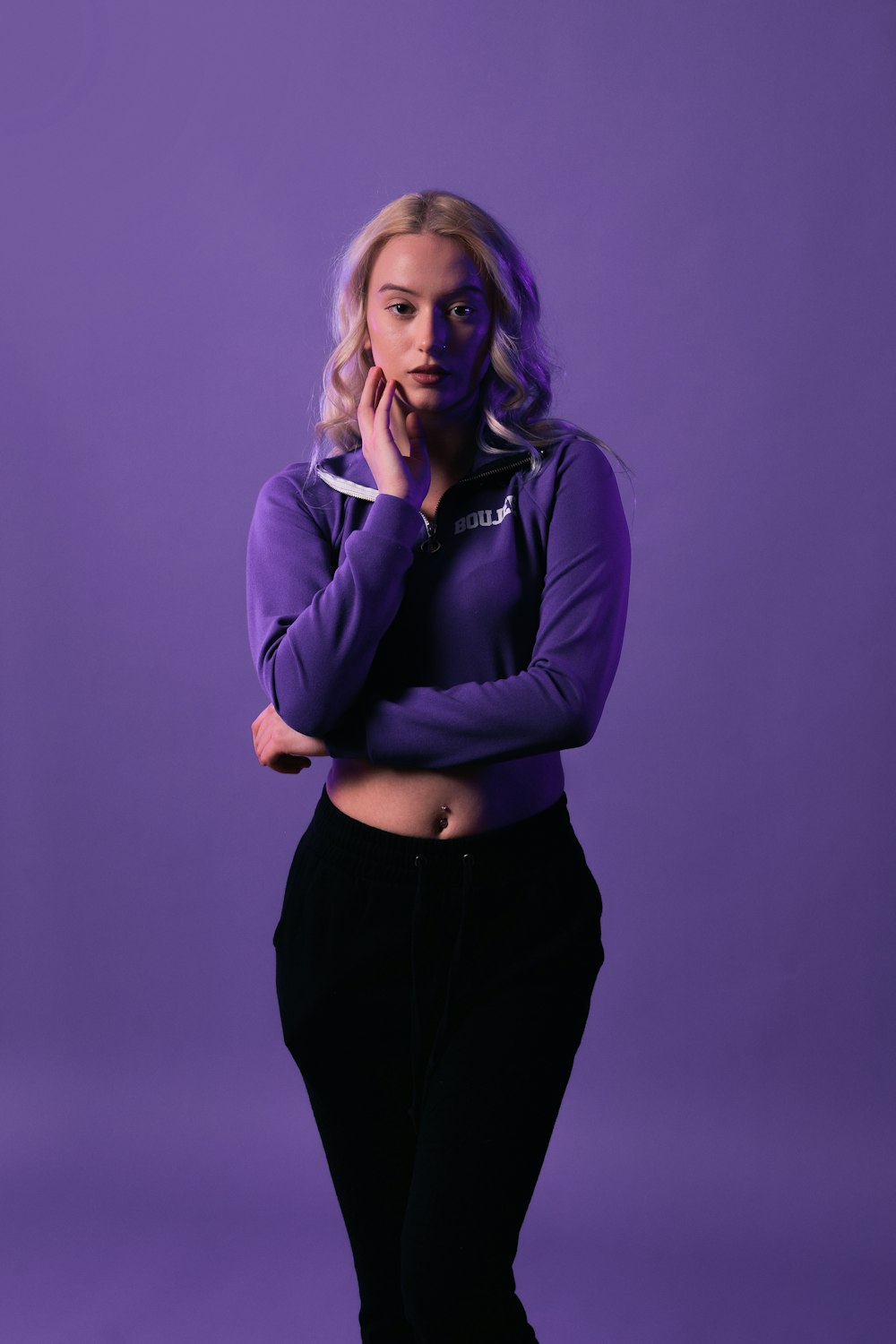 a woman in a purple shirt posing for a picture