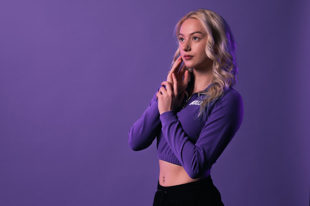 a woman posing for a picture in a purple shirt