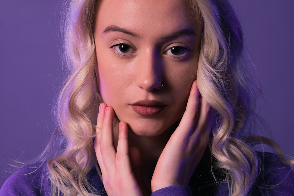 a woman with blonde hair is posing for a picture