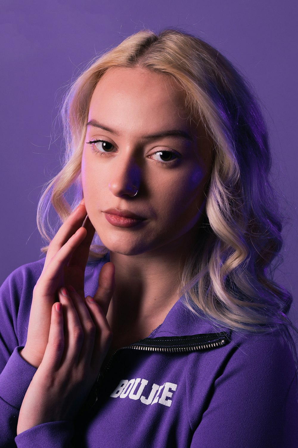 a woman in a purple shirt is posing for a picture