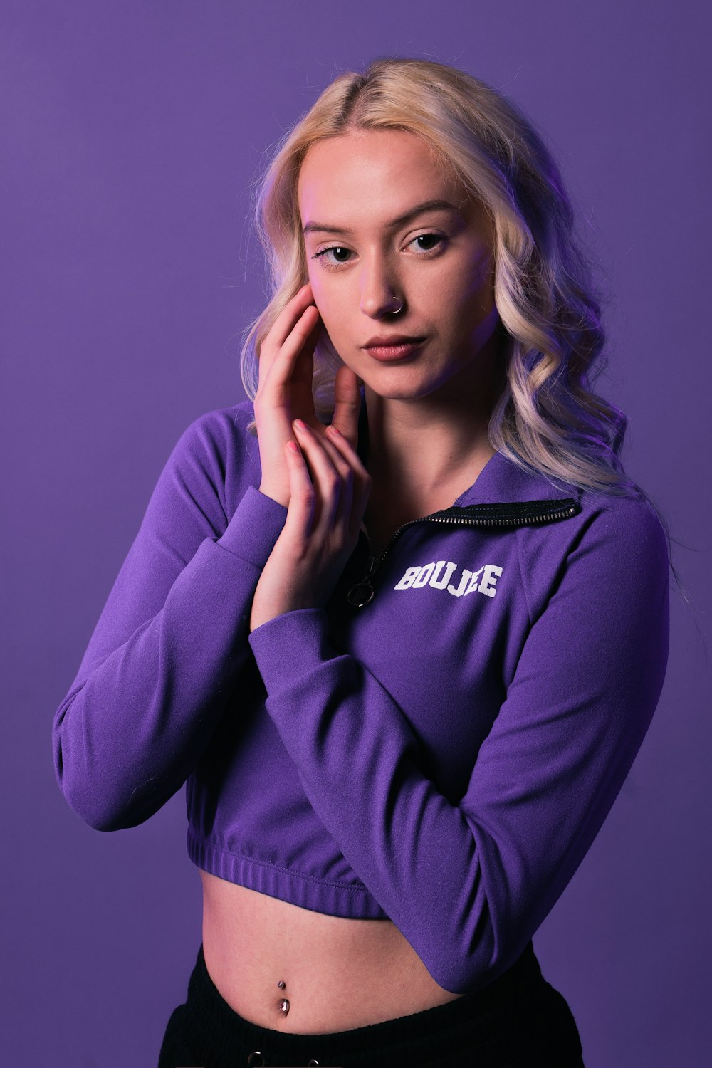 a woman in a purple shirt posing for a picture