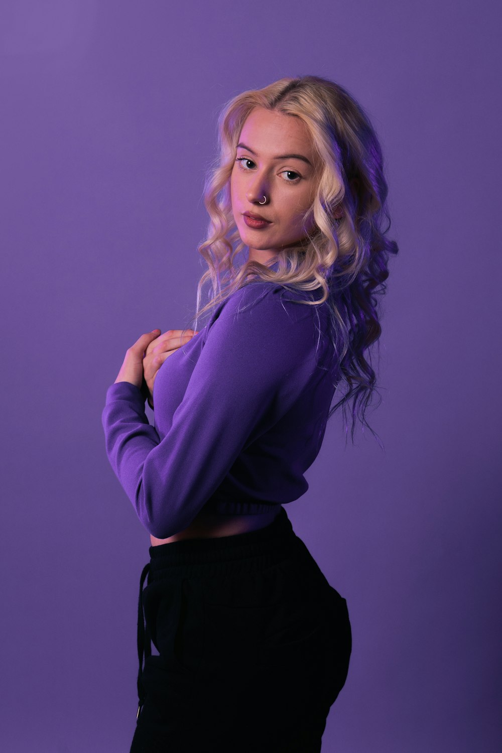 a woman in a purple shirt posing for a picture