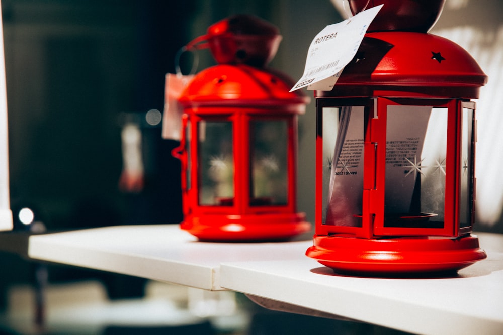 a couple of red lanterns sitting on top of a white shelf
