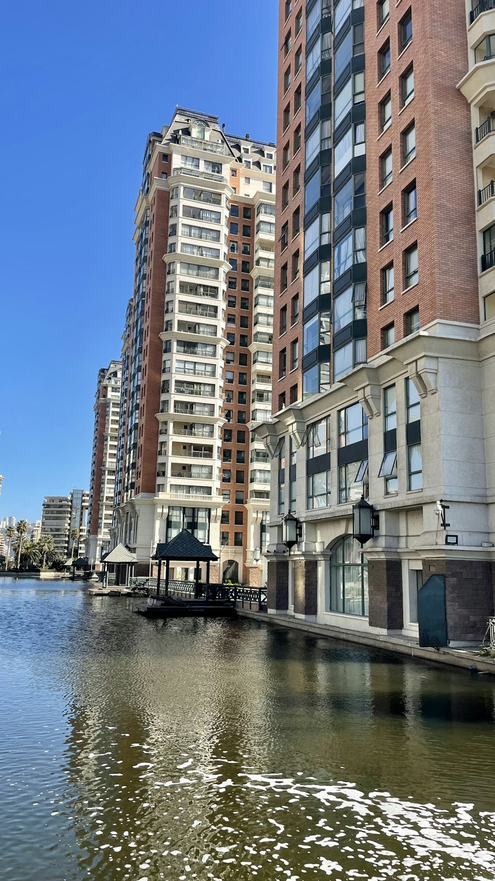 a body of water in front of tall buildings