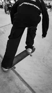 A dynamic shot of a skateboarder wearing a hoodie and funky shorts.