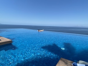 a large swimming pool with a boat in the distance