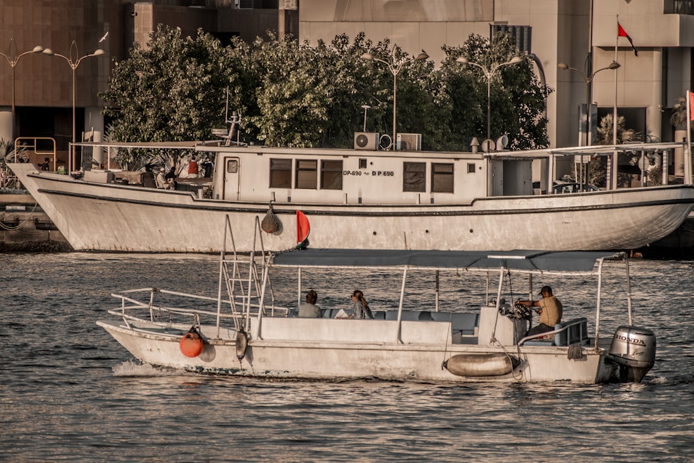 a couple of boats floating on top of a body of water