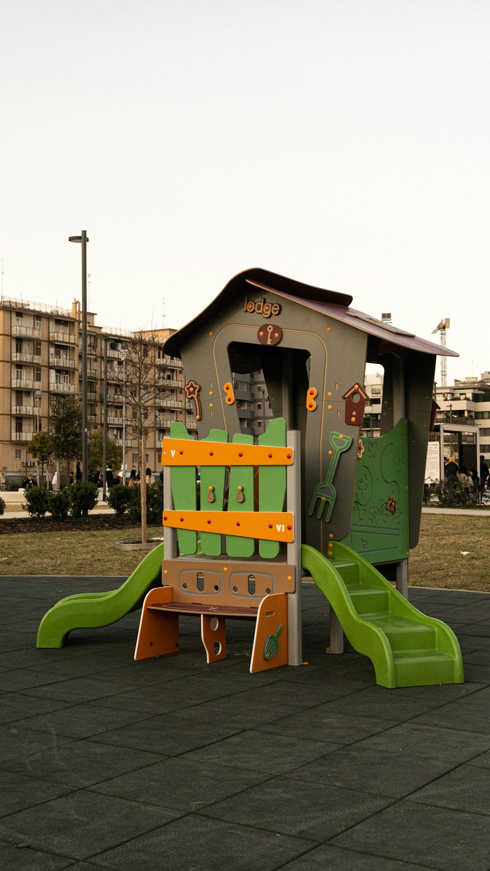 a children's play structure with a green slide