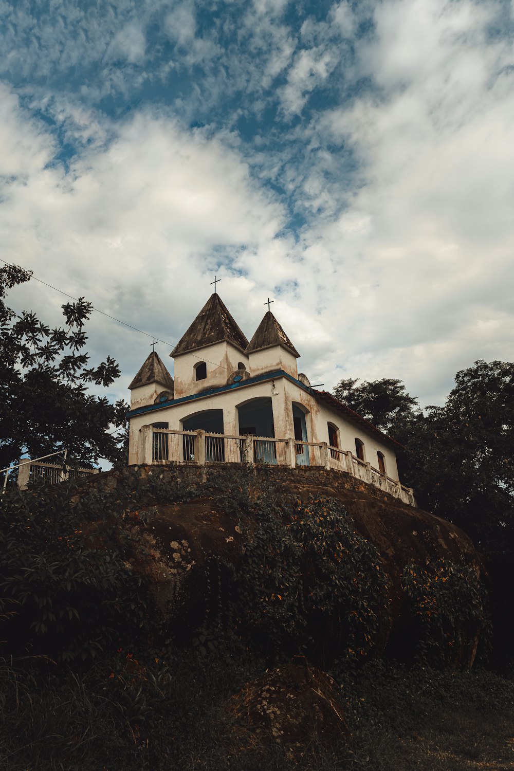 a large white building sitting on top of a hill