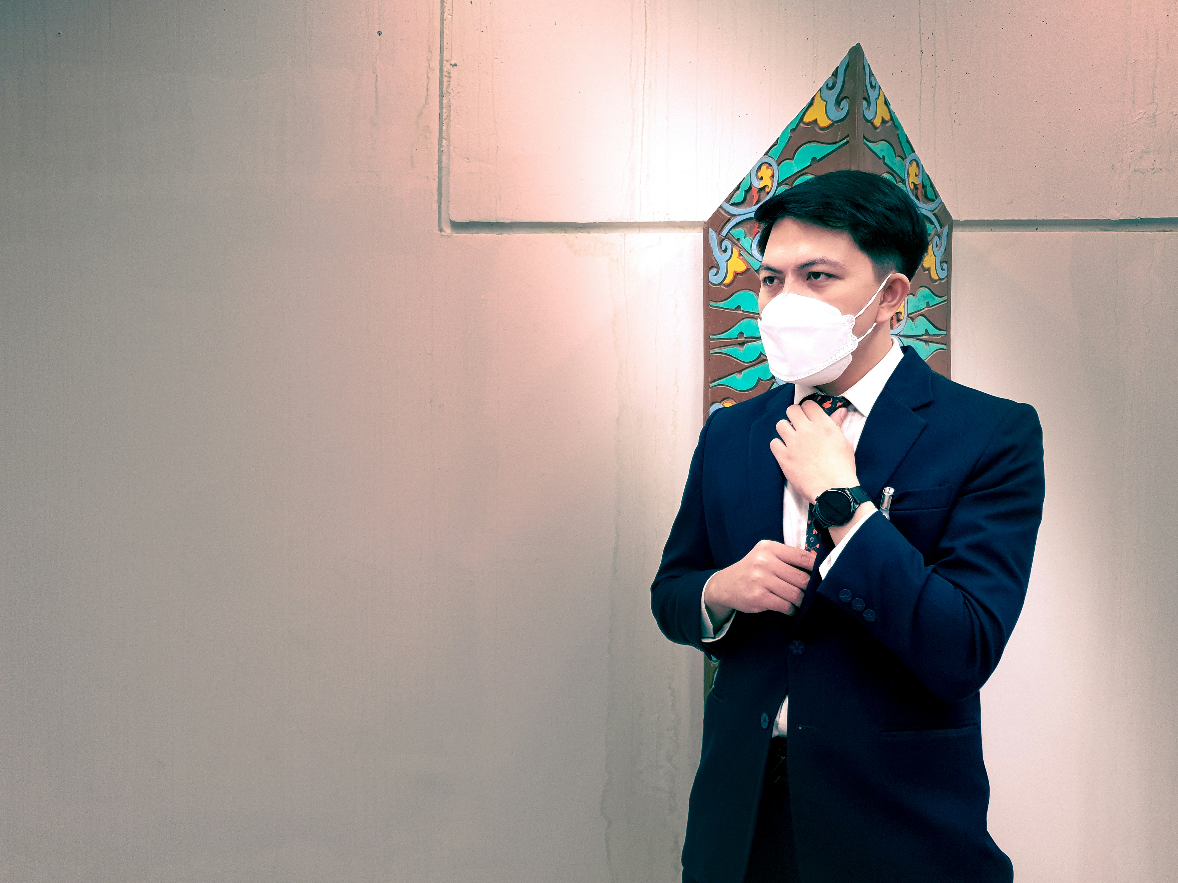 a man in a suit and tie holding a microphone