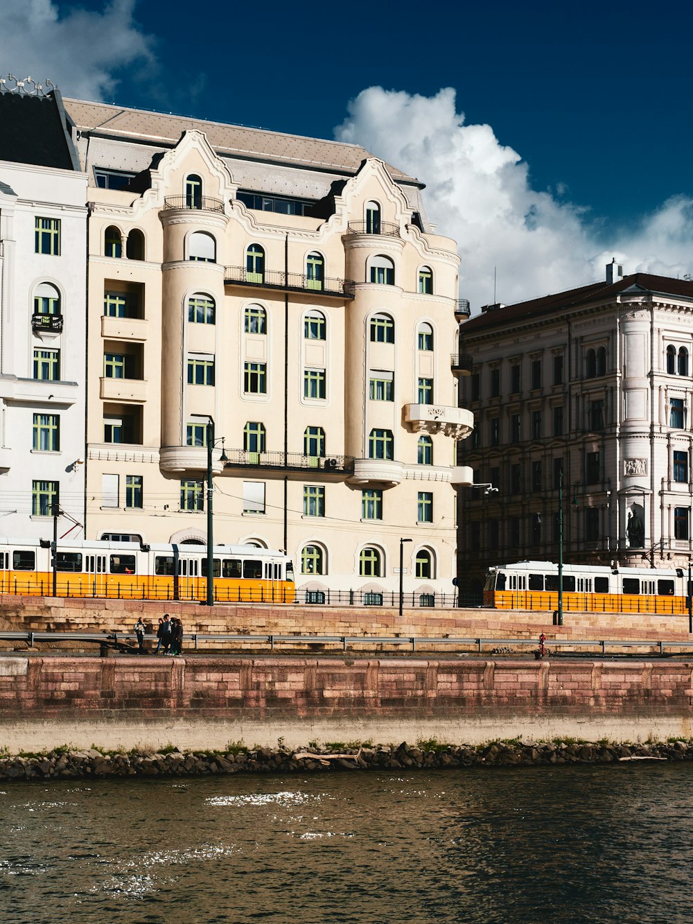 a large white building next to a body of water