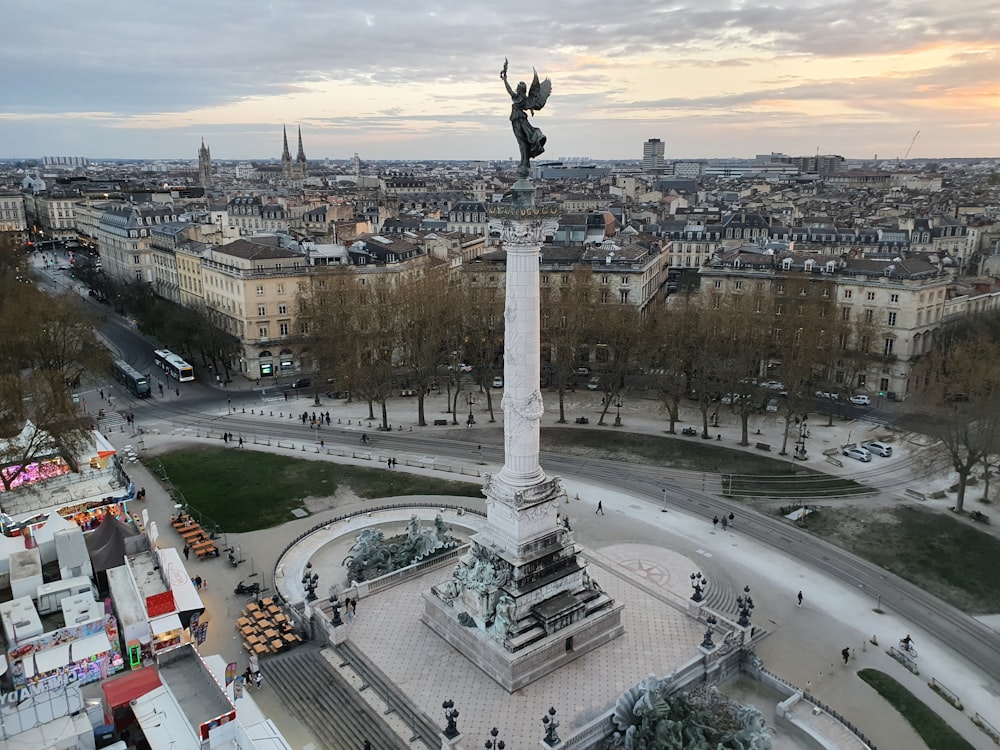 an aerial view of a city with a statue in the center