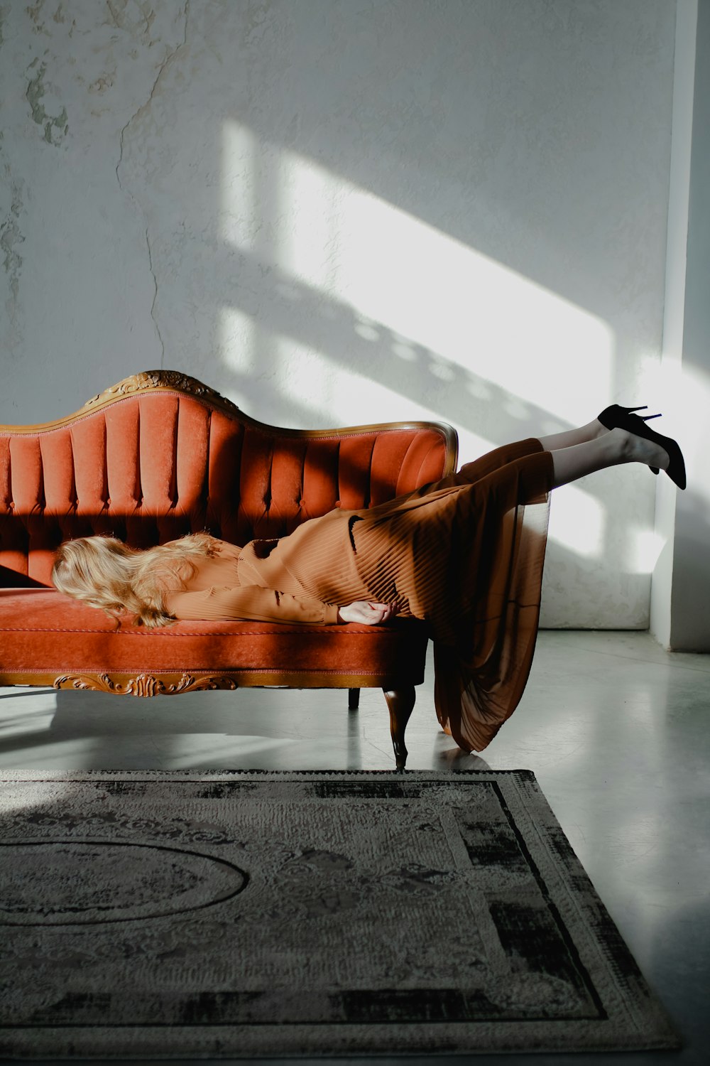 a woman laying on top of a couch in a room