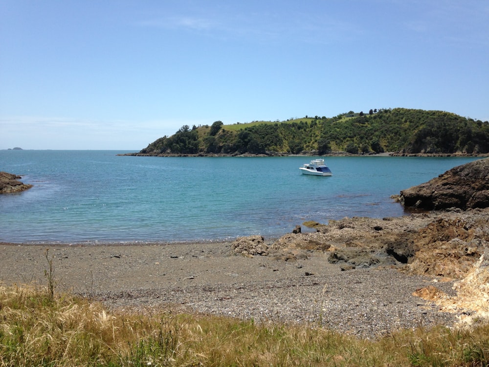 a boat is out on the water near the shore