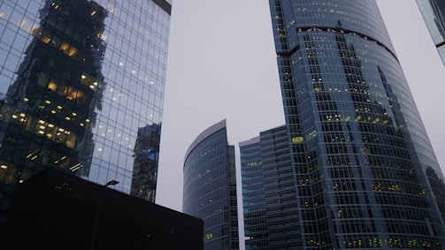 A bustling commercial office space with glass facades reflecting the city skyline.