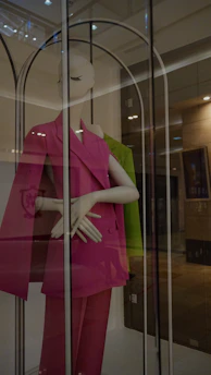 Soft pink women's suit shirt displayed on a mannequin with gentle natural lighting
