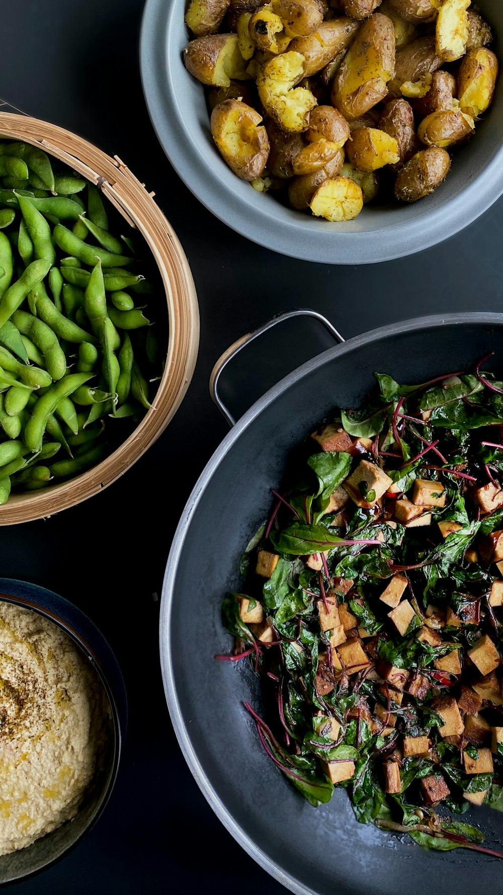 a table topped with plates of food and bowls of vegetables