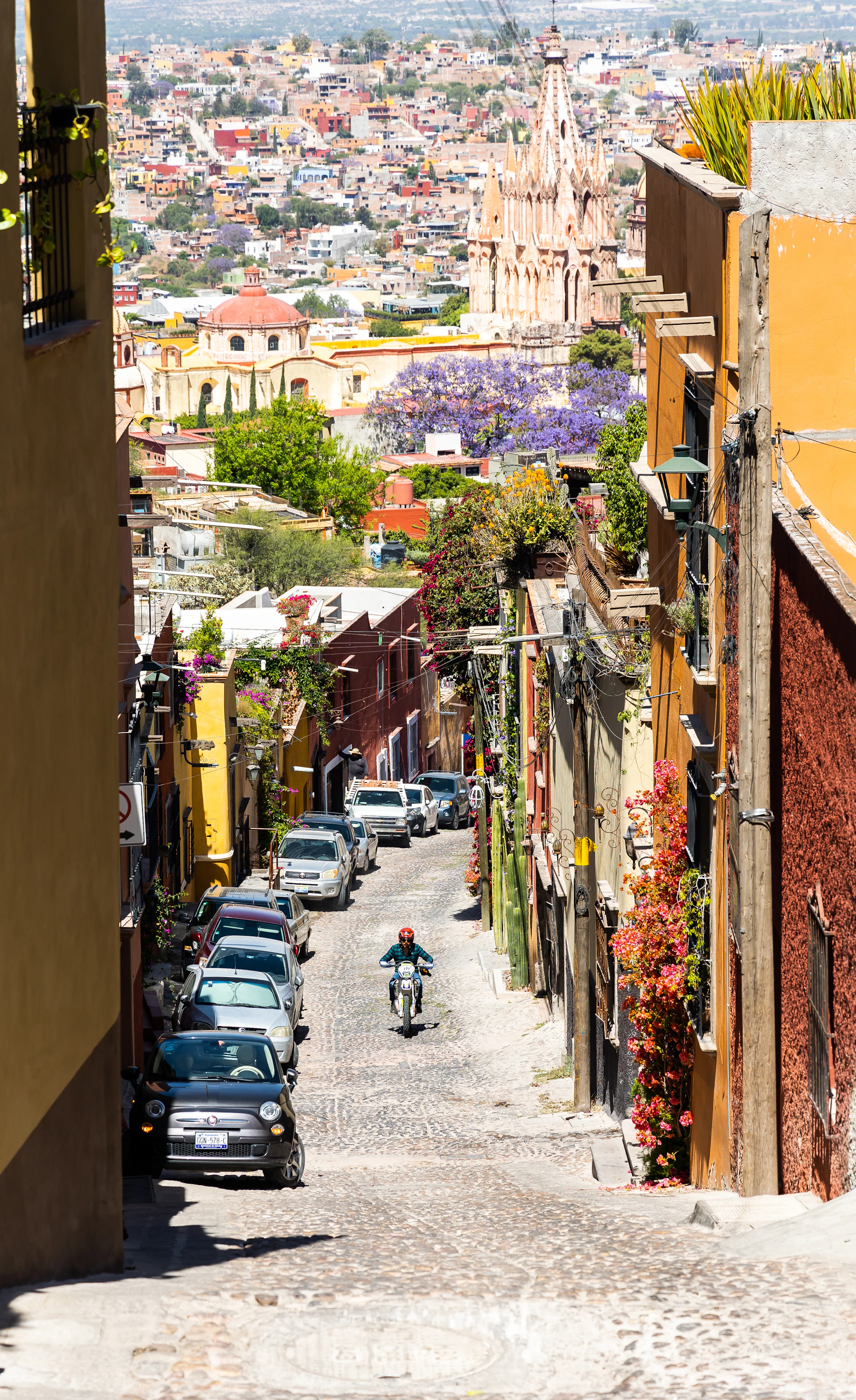 a motorcycle is parked on a cobblestone street
