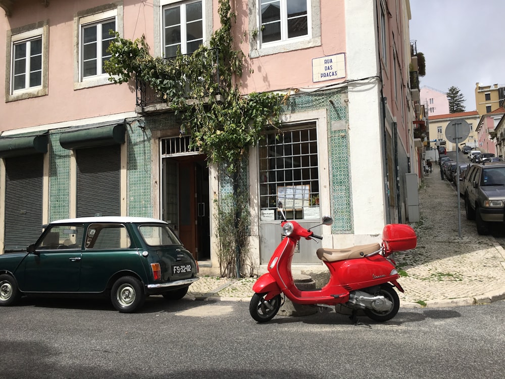 a red scooter parked in front of a building