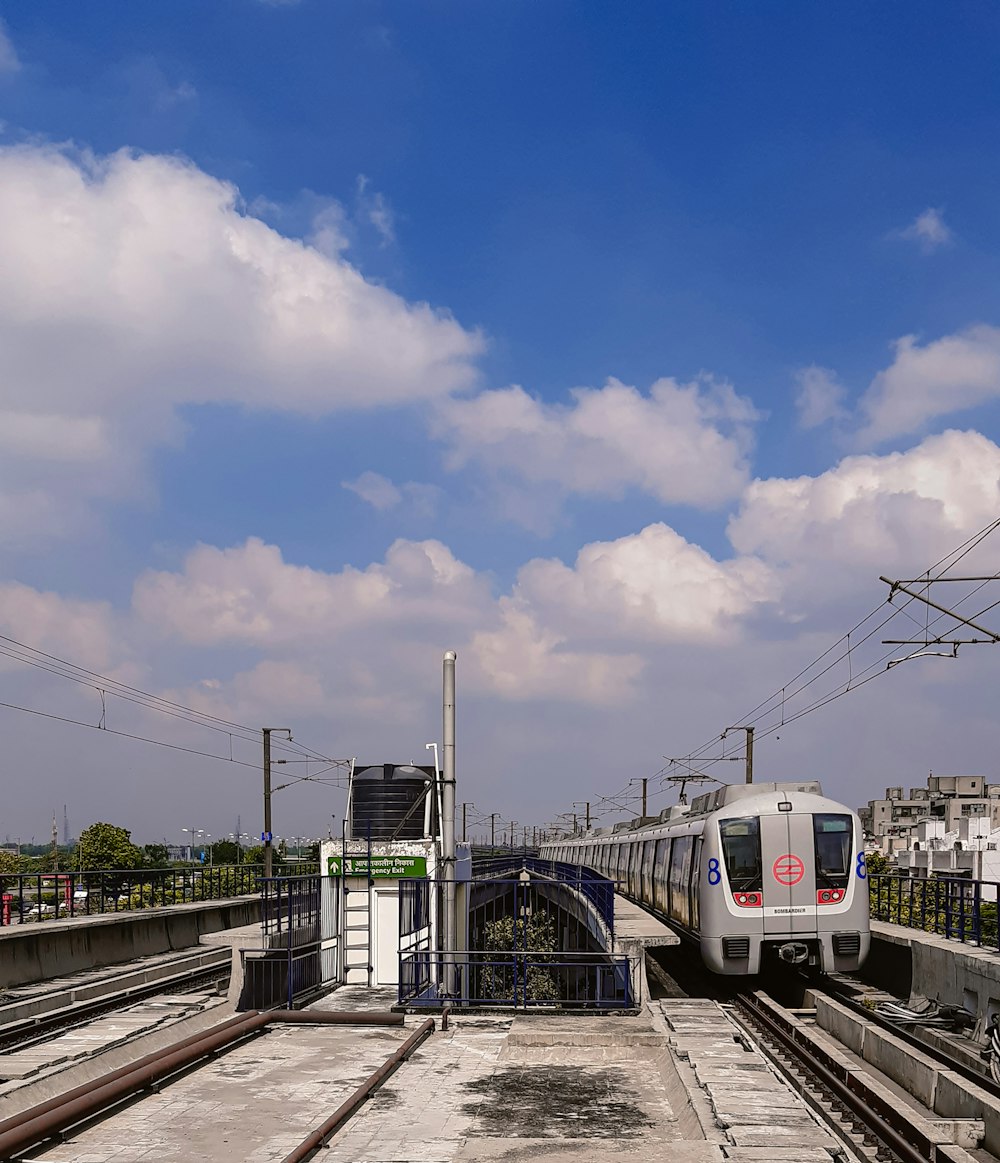 a train traveling down tracks next to a train station