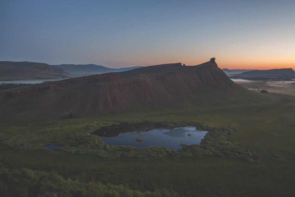 a mountain with a lake in the middle of it