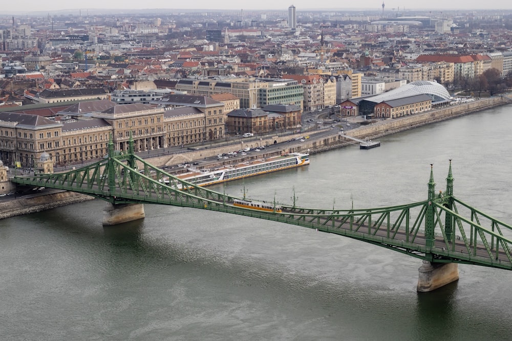 a bridge over a river with a city in the background