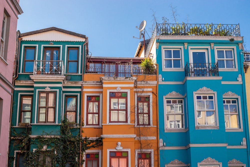 a row of multicolored buildings with balconies