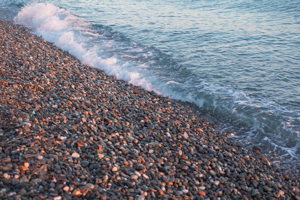 a beach with a wave coming in to the shore