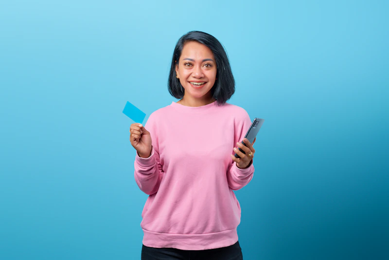 Sugar baby holding a credit card and cell phone, ready for luxury and connection.