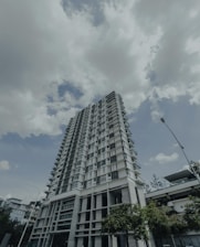a tall white building sitting next to a street