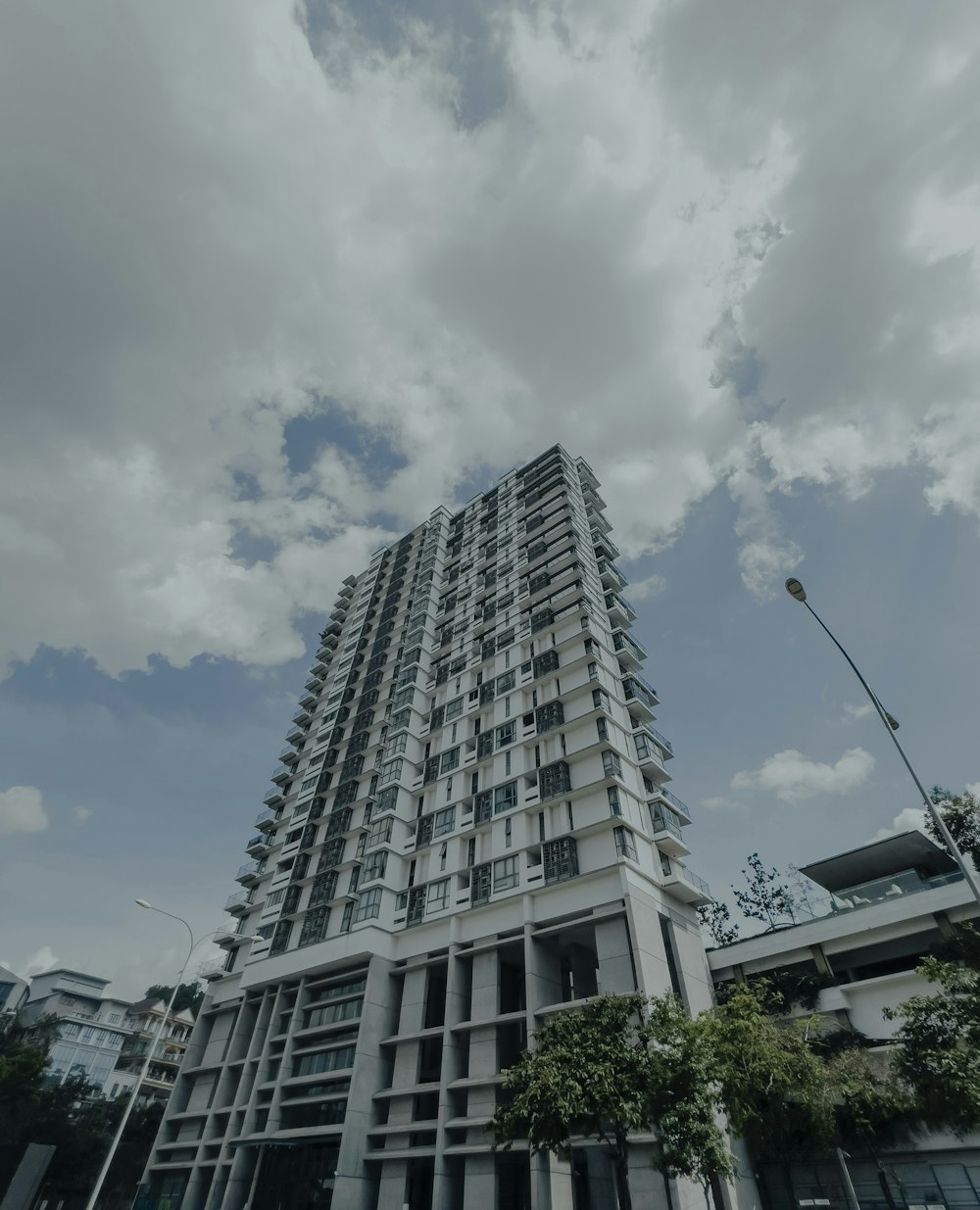 a tall white building sitting next to a street