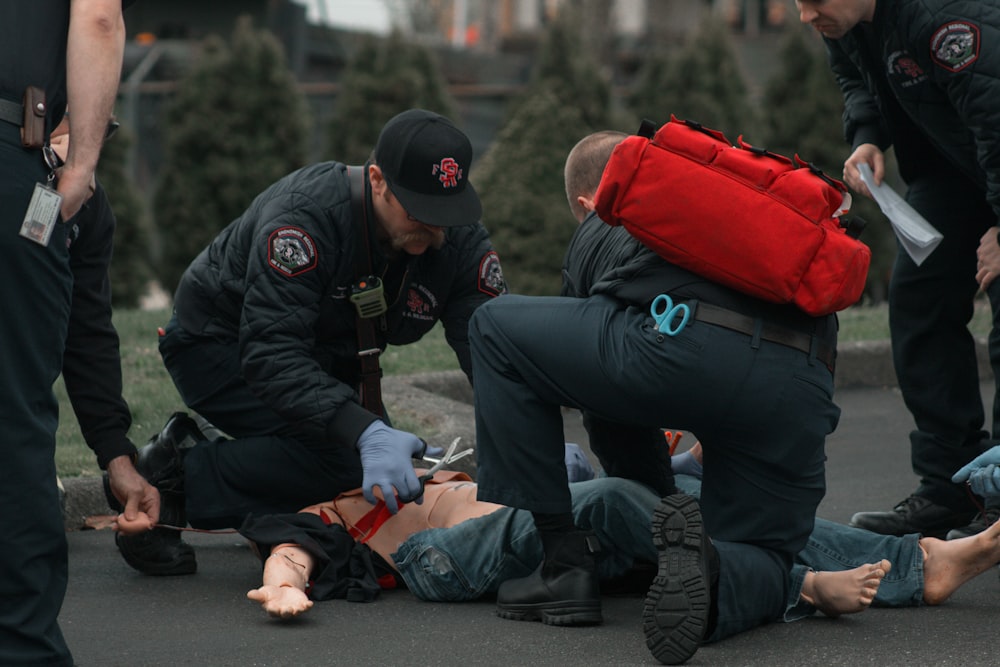 a group of people with a person on the ground