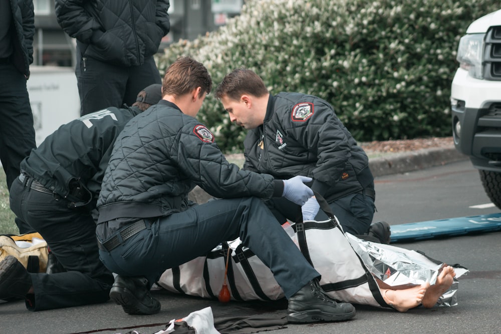 a couple of men that are sitting on the ground