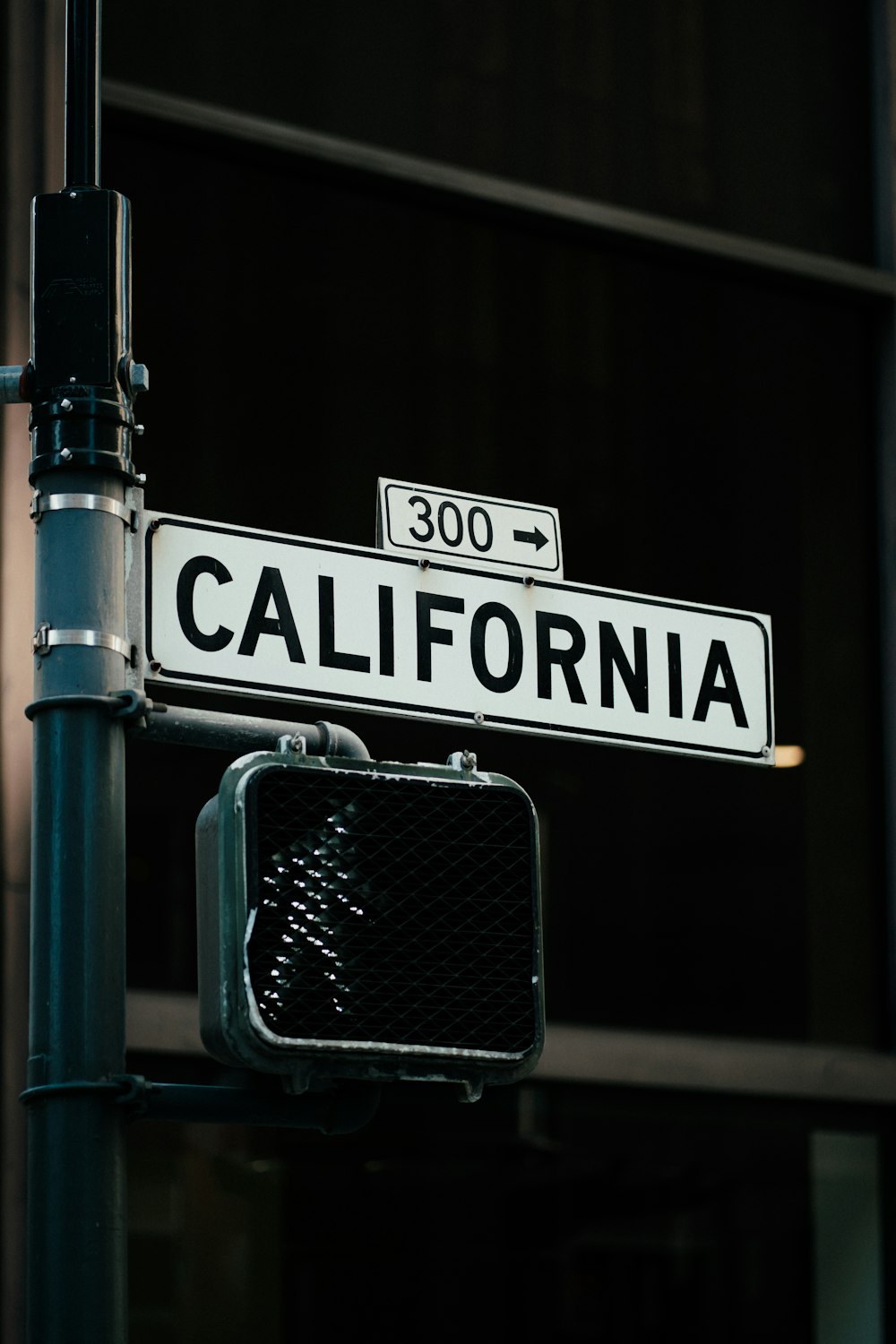 a close up of a street sign with a building in the background