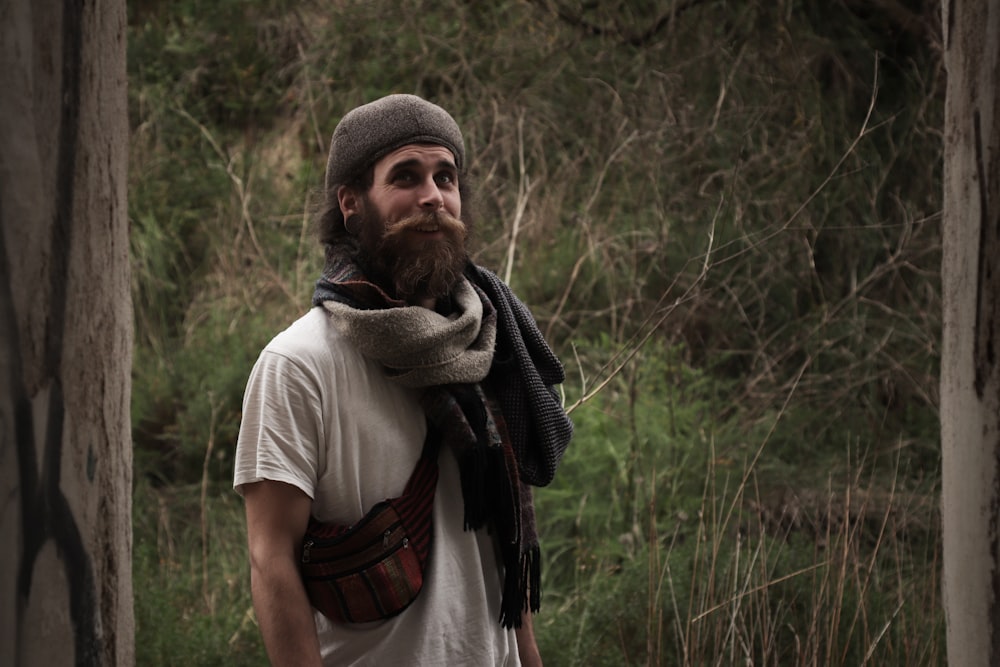 a man with a beard wearing a hat and scarf