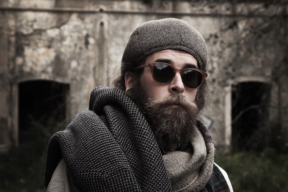 a man with a beard wearing sunglasses and a scarf