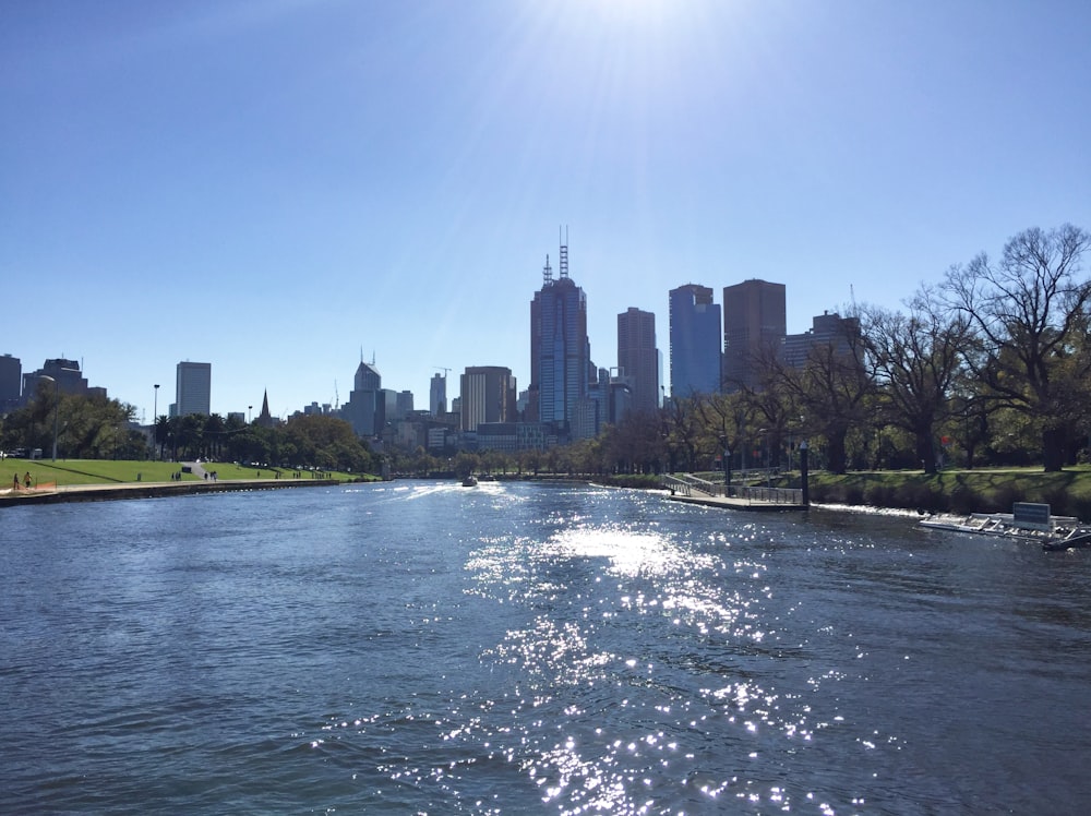 a body of water with a city in the background