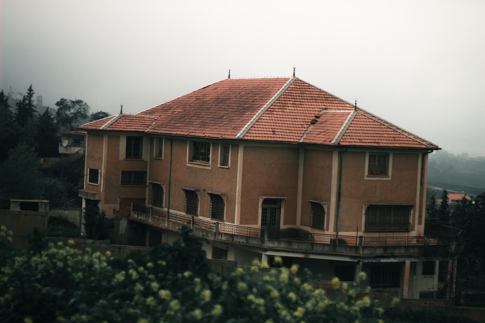 a building with a red roof and a balcony