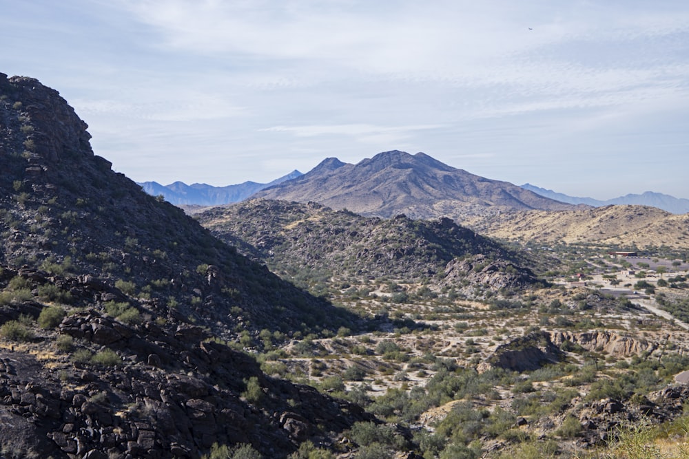 a view of a mountain range with a winding road in the foreground