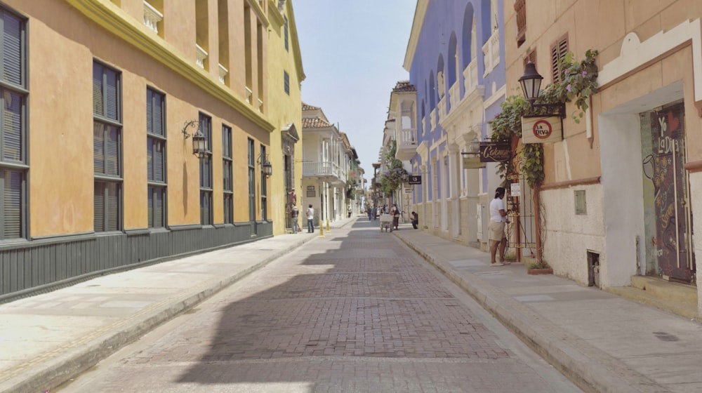 a narrow city street lined with tall buildings