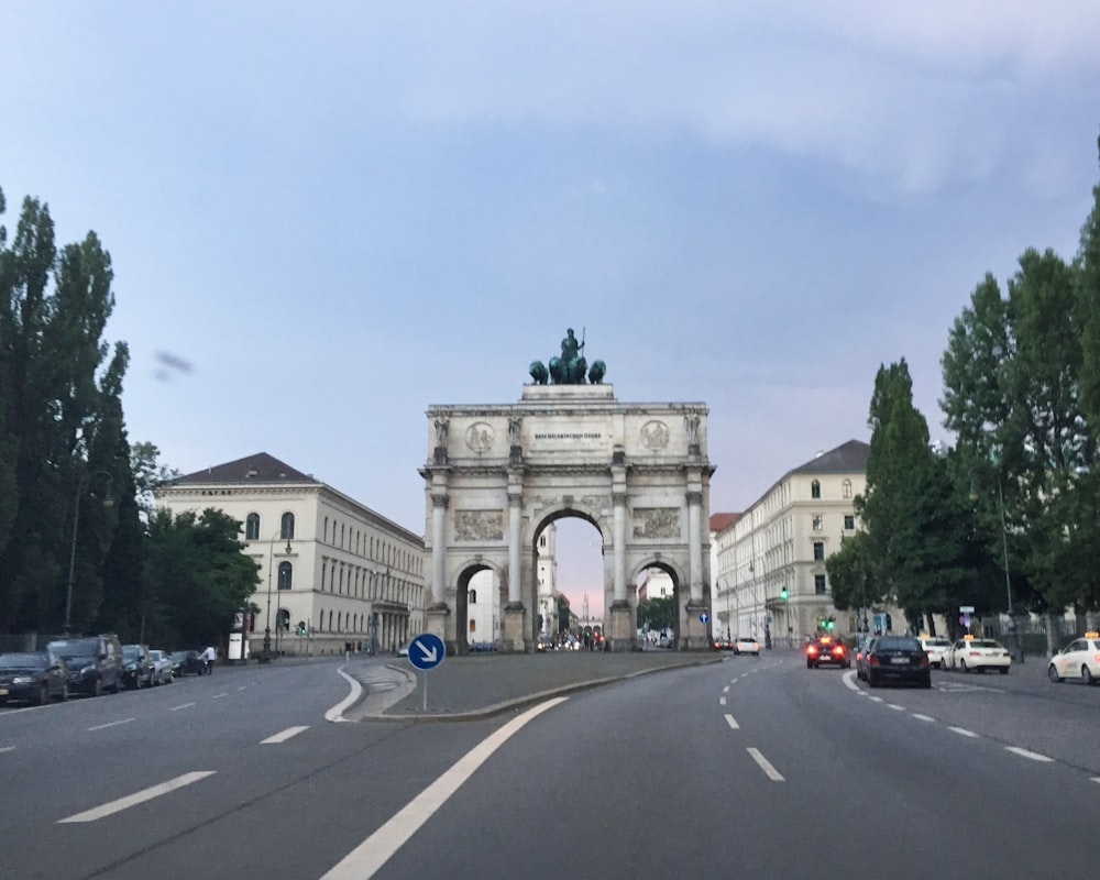 a city street with a large arch in the middle of it