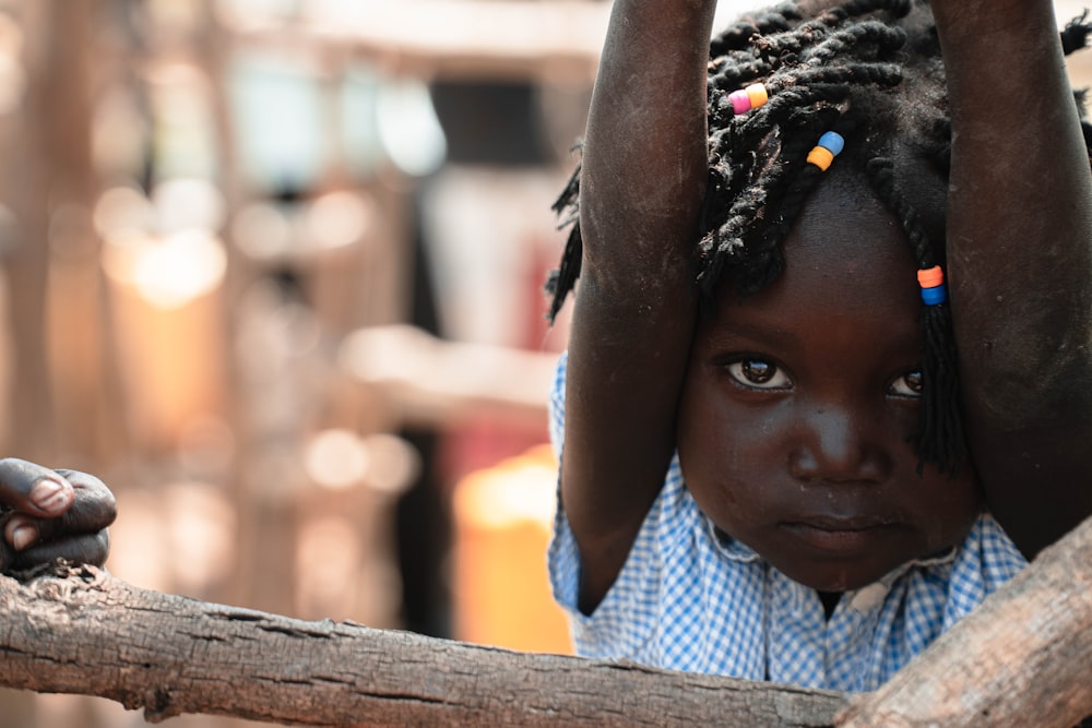 a little girl with dreadlocks on her head