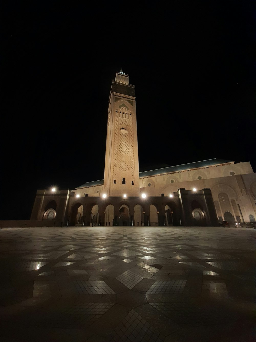 a large clock tower lit up at night