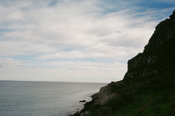 A large body of water sitting next to a rocky cliff — Monemvasia, Greece